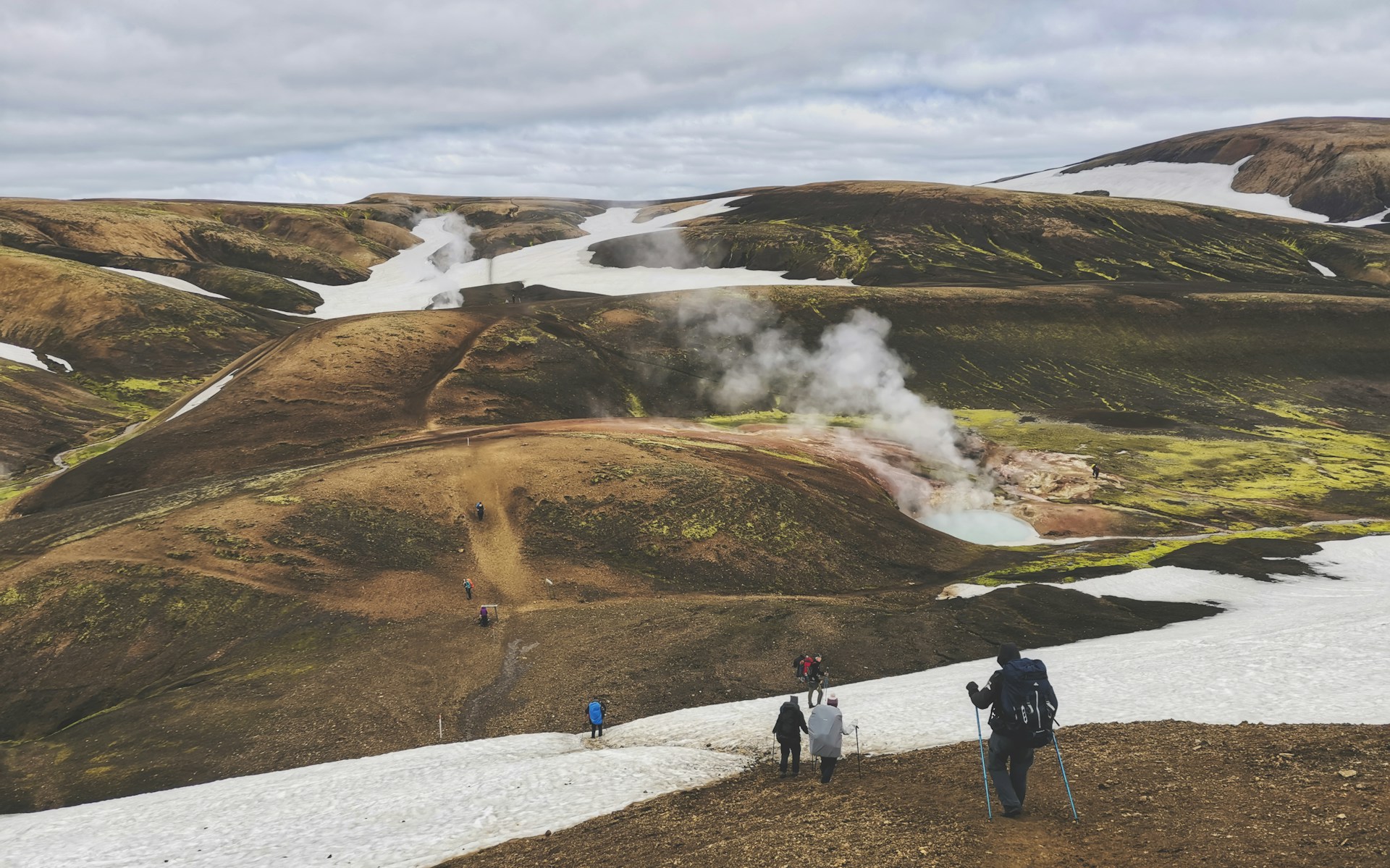 Hikers crossing the colorful Laugavegur landscape in Iceland