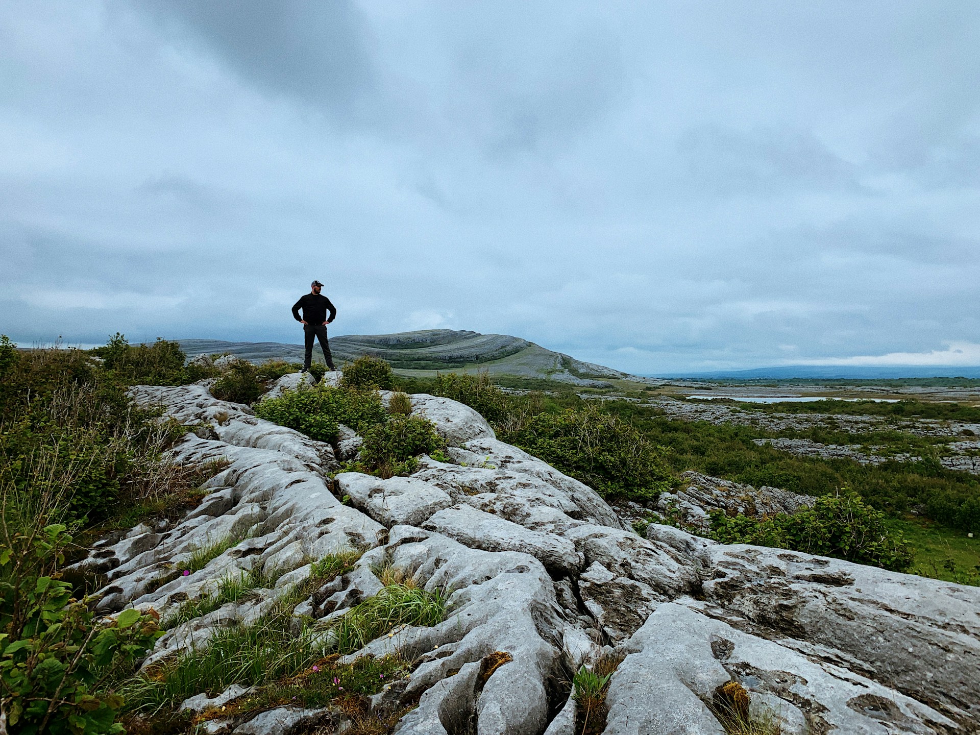 A hiker standing on the limestone landscape of Burren National Park