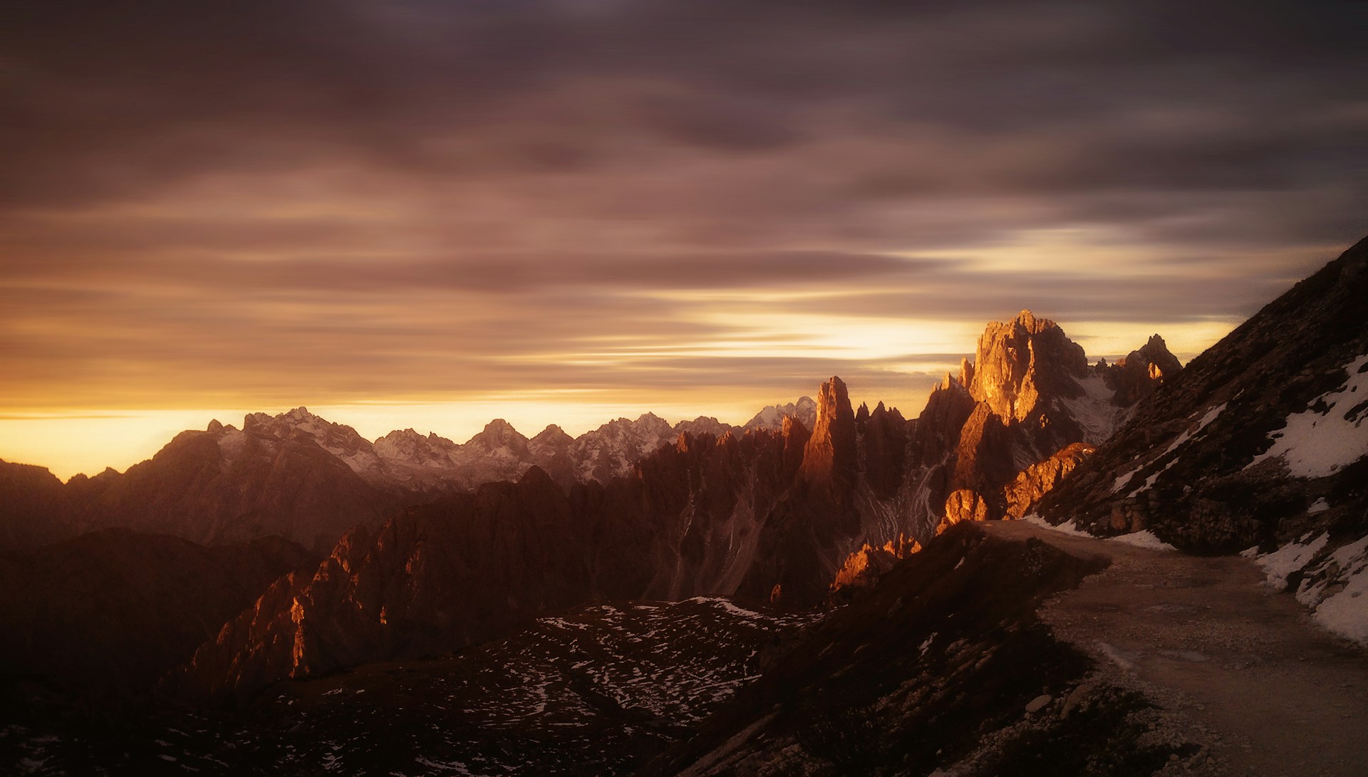 The Dolomites glowing at sunrise along the Tre Cime di Lavaredo hike