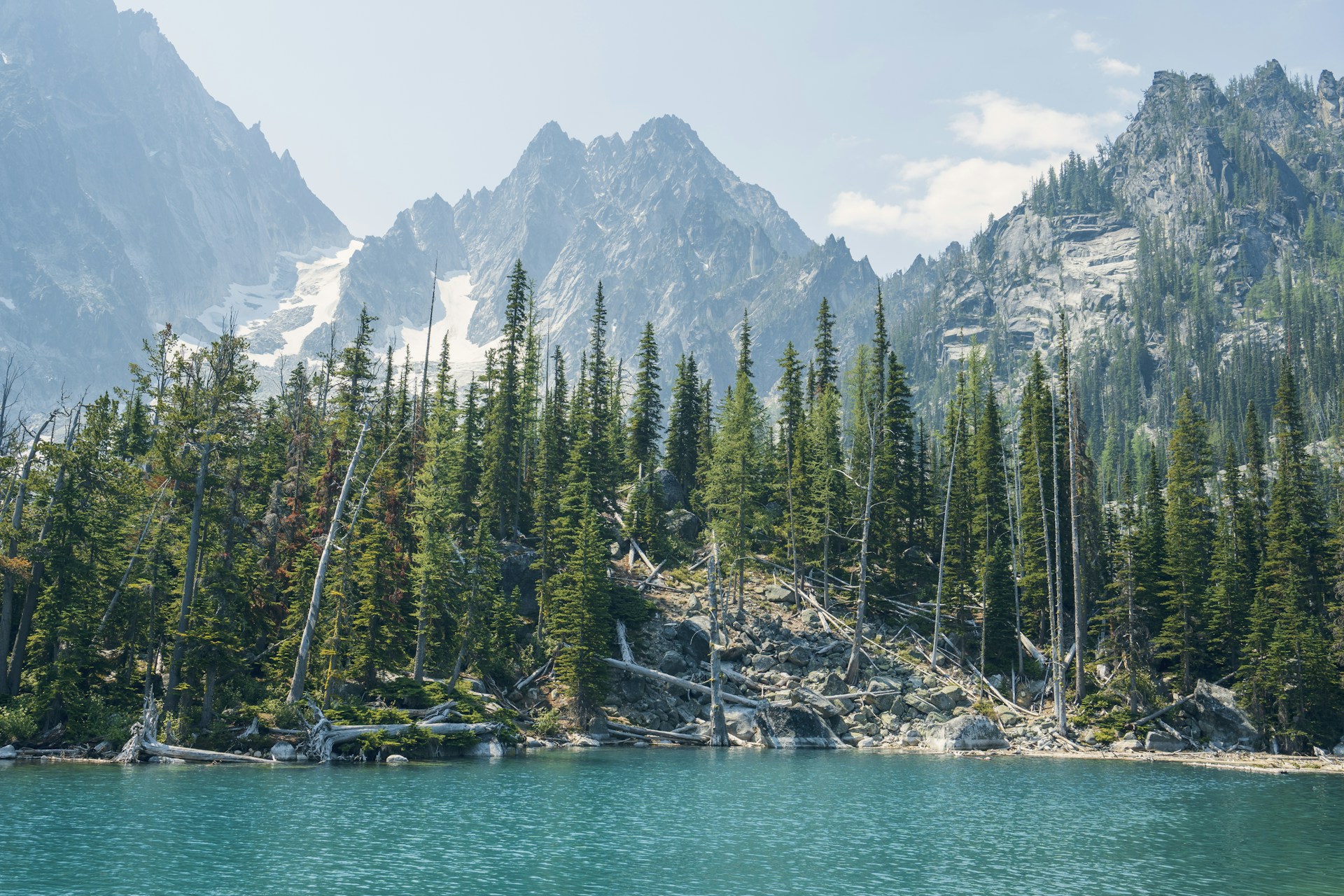 Colchuck Lake surrounded by evergreen forest and granite peaks
