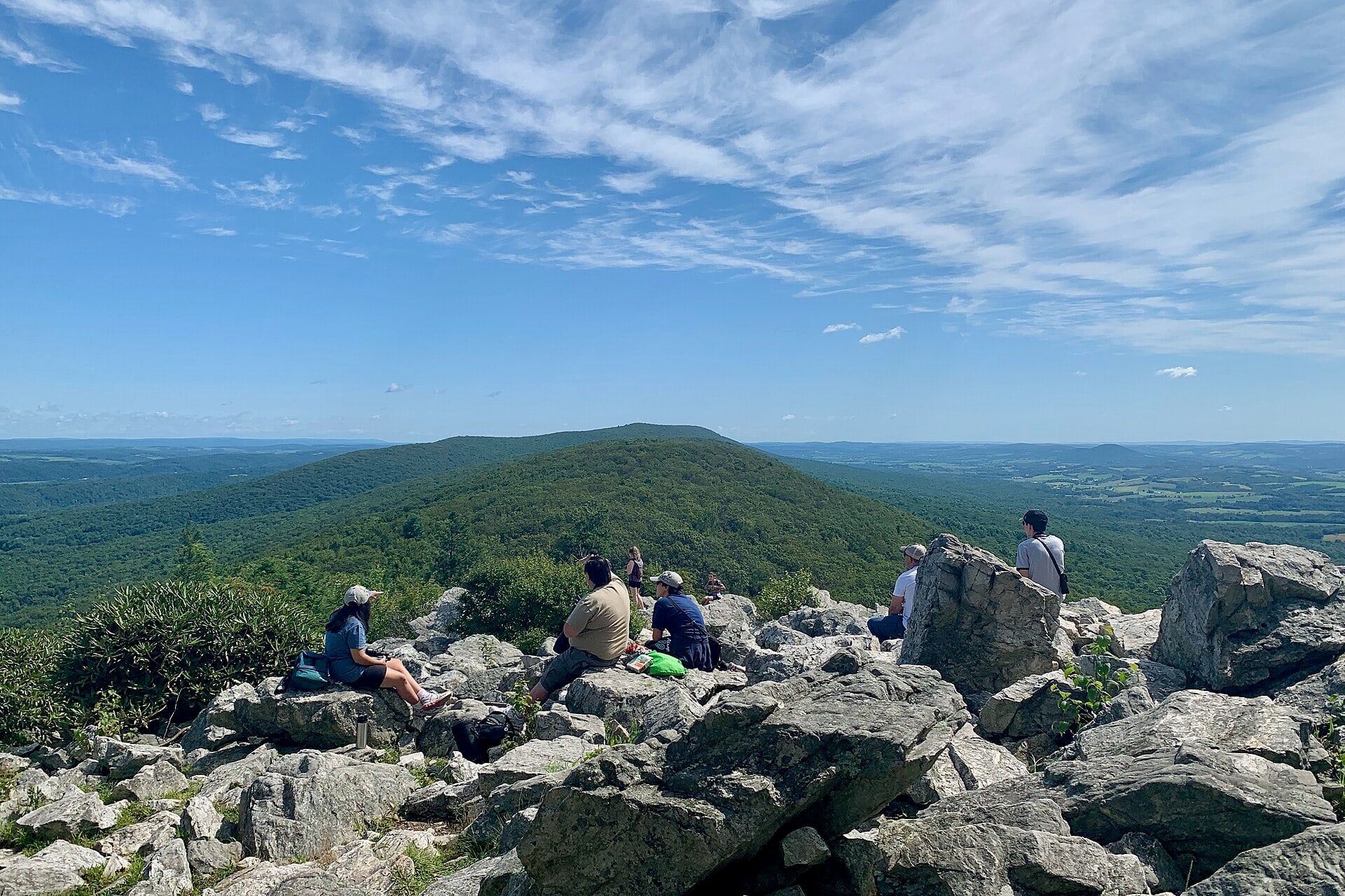 Hikers enjoying the expansive view from Hawk Mountain's North Lookout