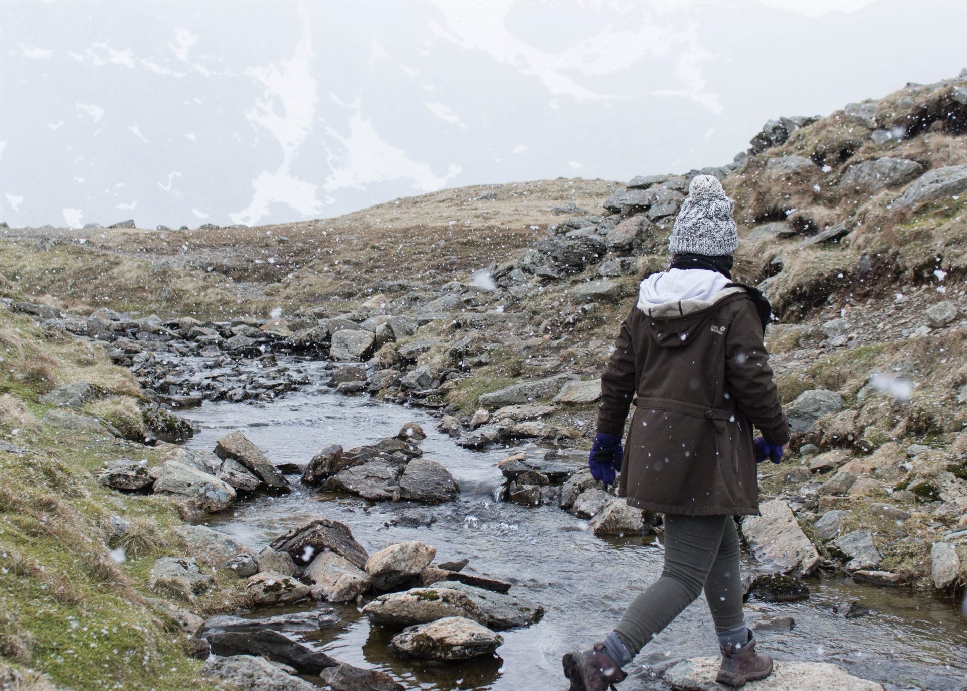 hiker crossing stream