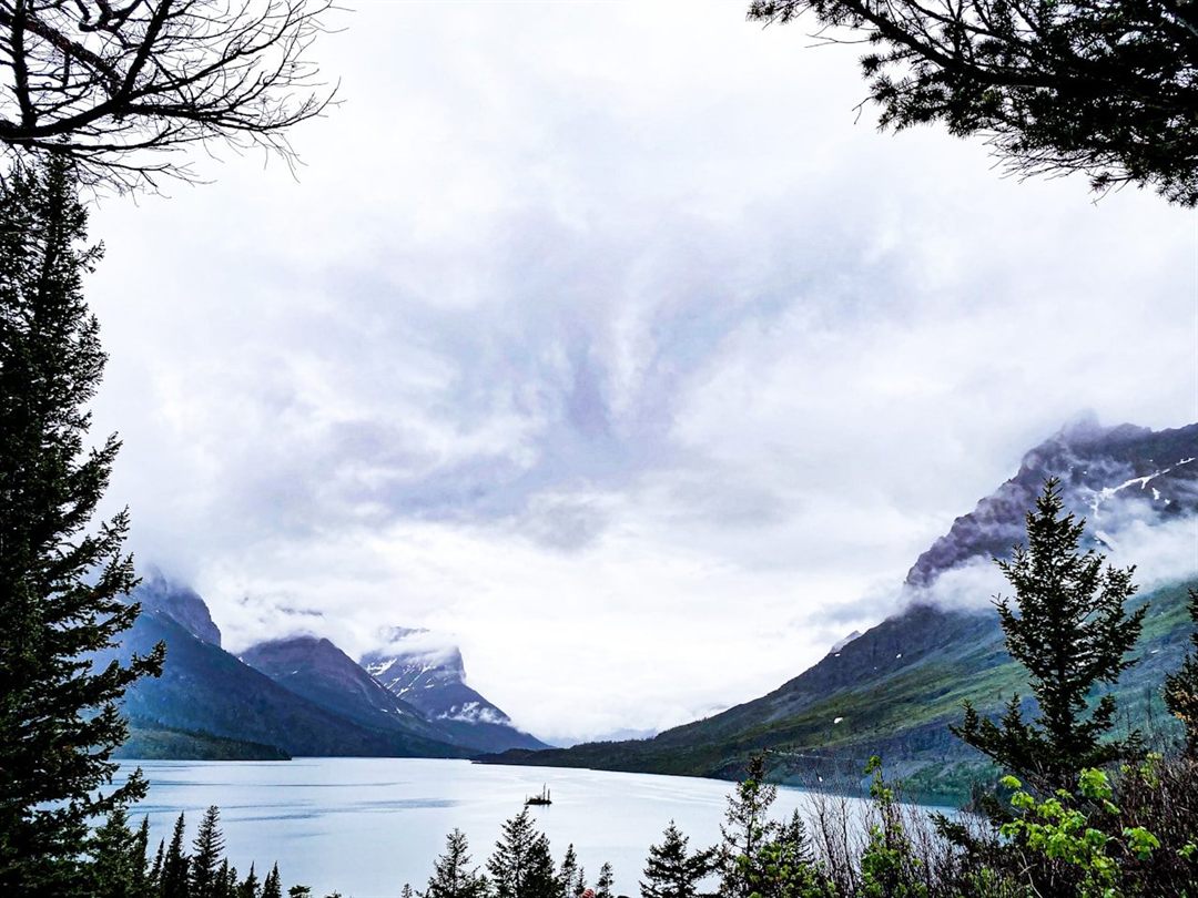 A turquoise alpine lake surrounded by mountains in Glacier National Park