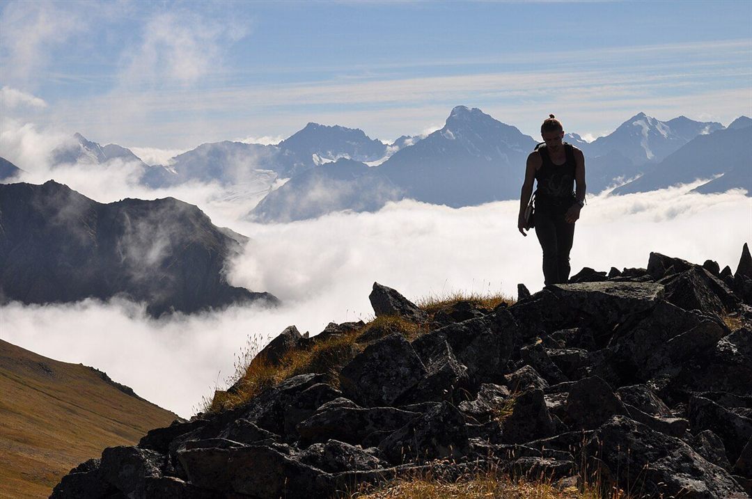 A hiker above the clouds in Chugach State Park near Anchorage, Alaska