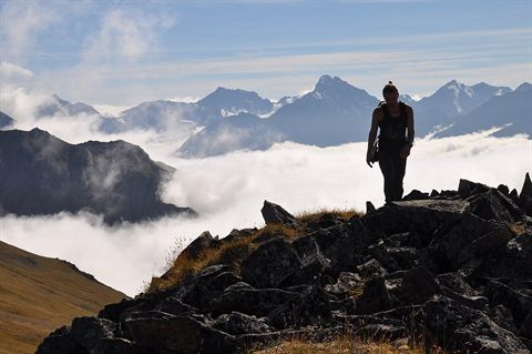 A hiker above the clouds in Chugach State Park near Anchorage, Alaska