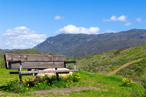 Trailside bench overlooking green mountains in Thousand Oaks