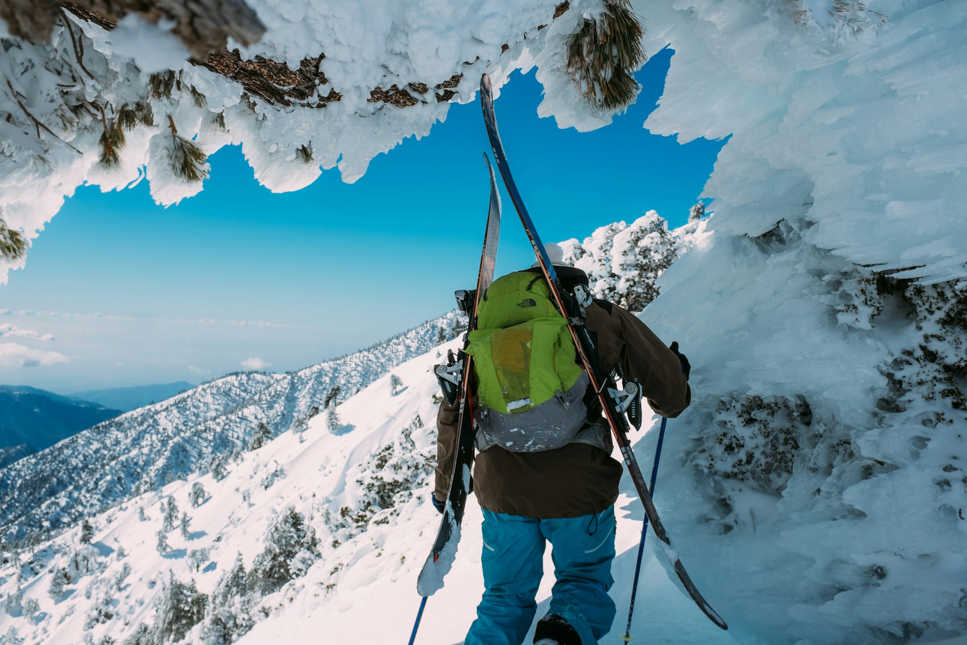 A hiker crossing the snowy slopes of Mount Baldy
