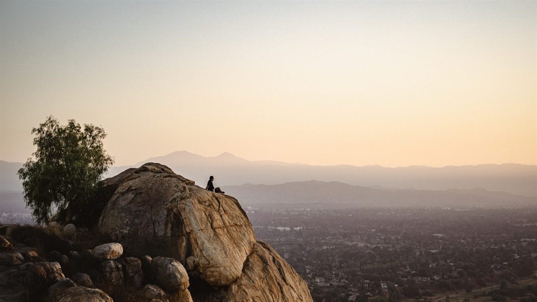 Hikers overlooking Riverside from Mount Rubidoux at sunset