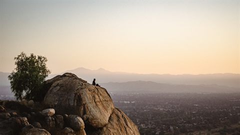 Hikers overlooking Riverside from Mount Rubidoux at sunset