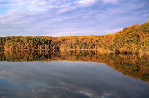 Autumn forest reflected in Liberty Reservoir in Maryland