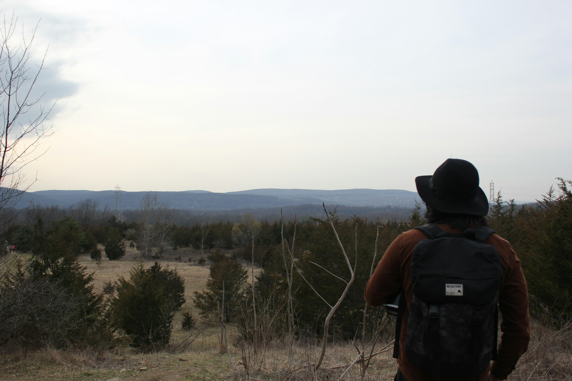 A hiker overlooking autumn fields on the Stairway to Heaven Trail