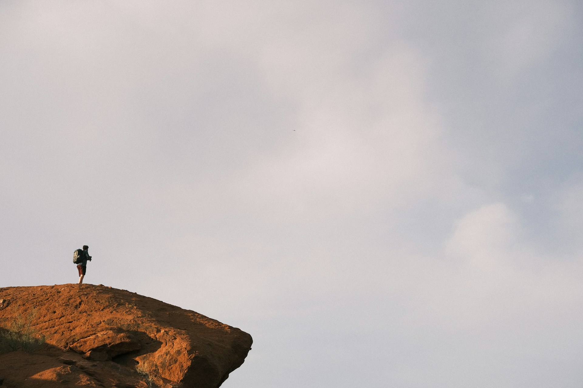 A hiker standing on Camelback Mountain above Phoenix