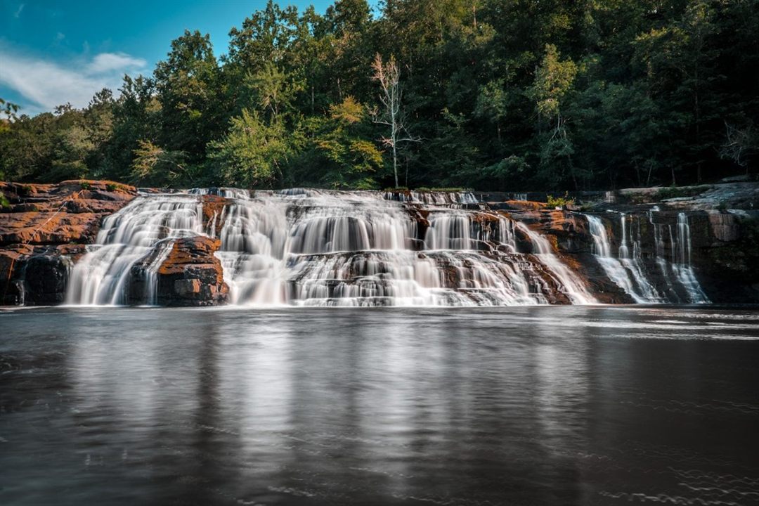Wide waterfall flowing over rock ledges in northern Alabama