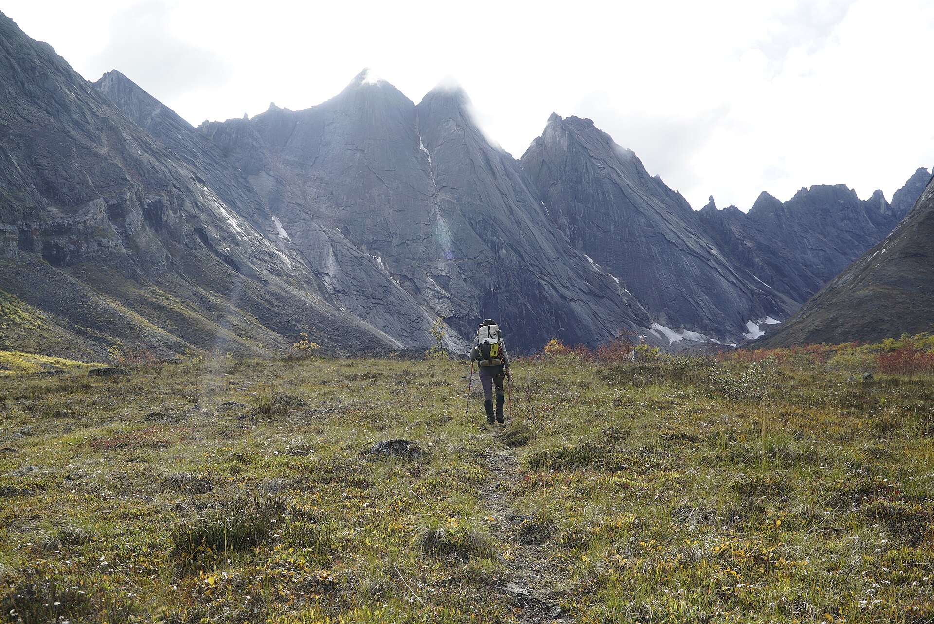 A National Park Service ranger backpacking toward the Arrigetch Peaks
