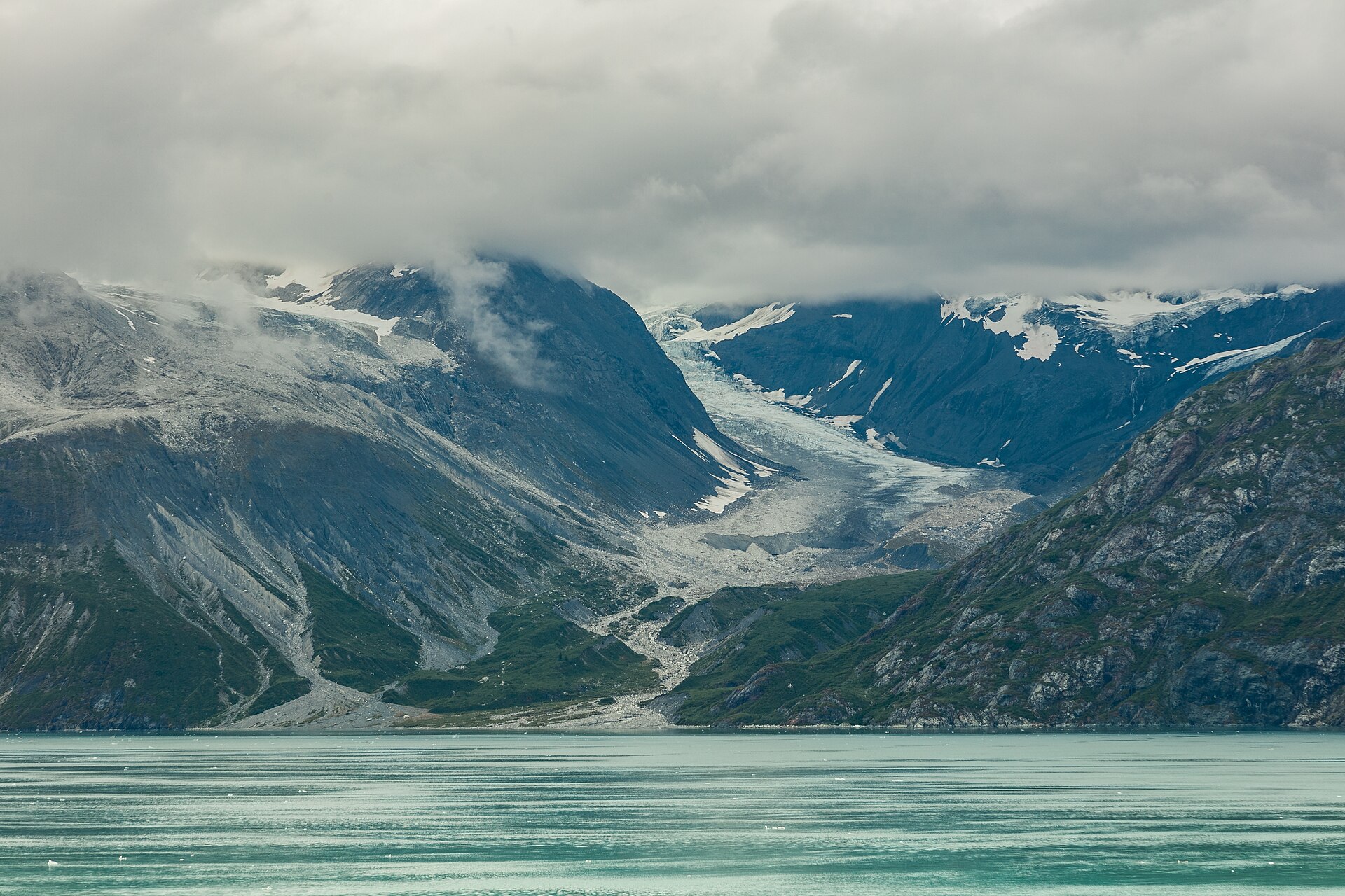 Johns Hopkins Glacier flowing between mountains in Glacier Bay