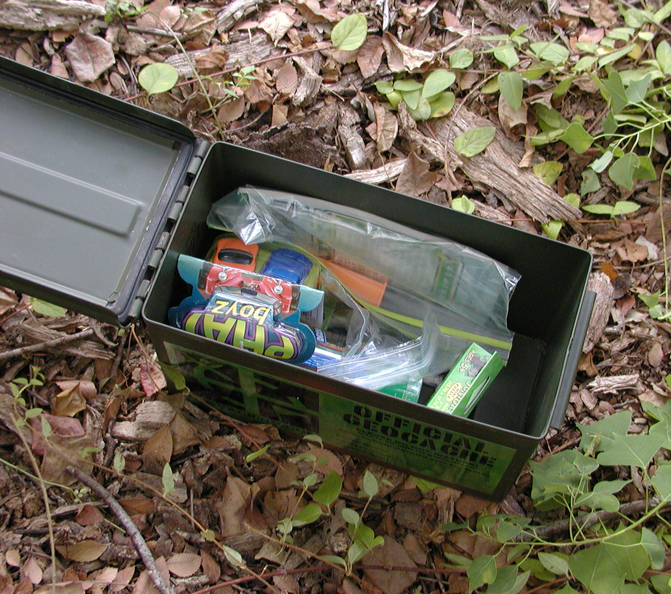 A classic ammunition-box geocache filled with trade items