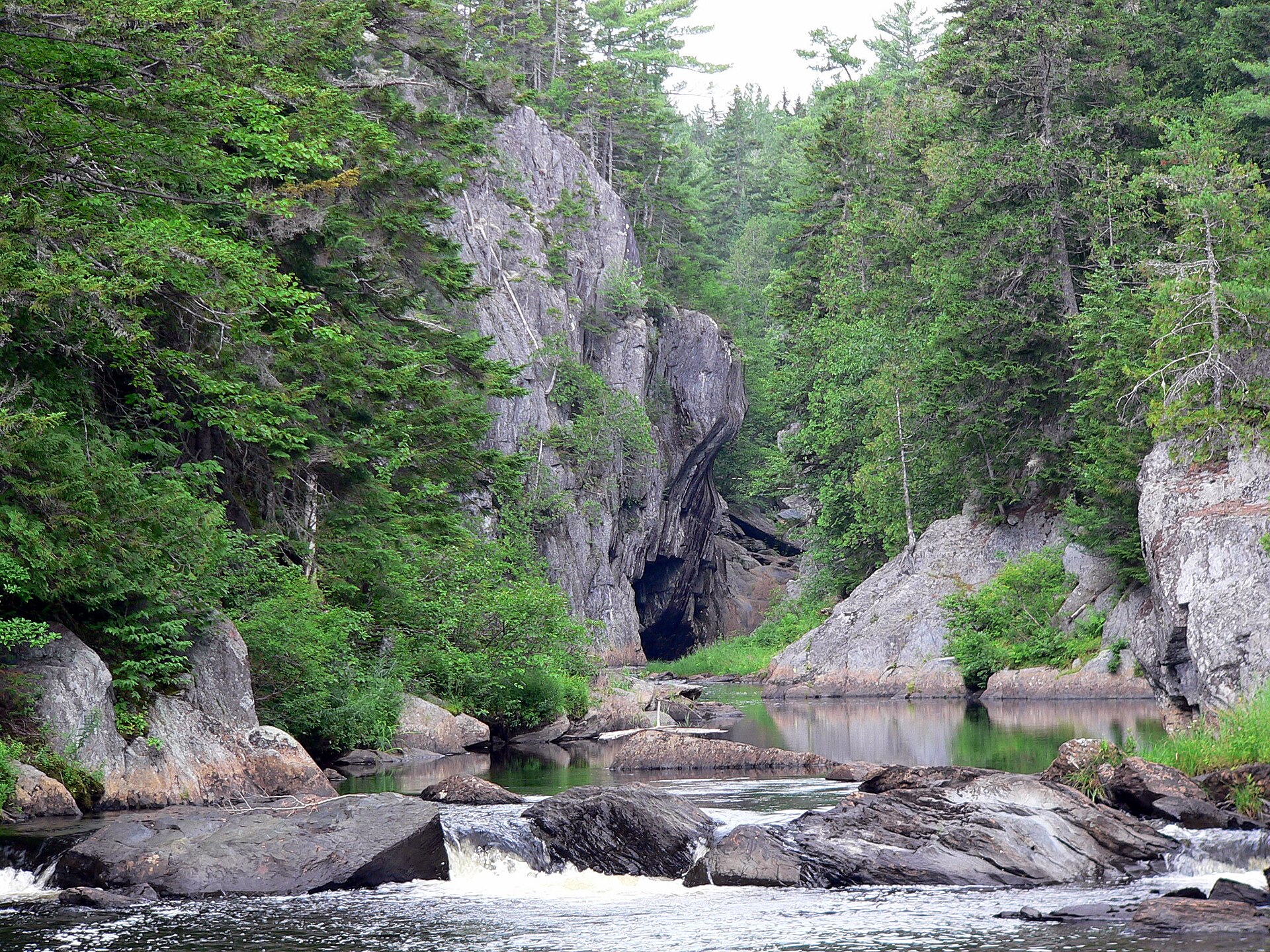 Water flowing between the forested cliffs of Gulf Hagas