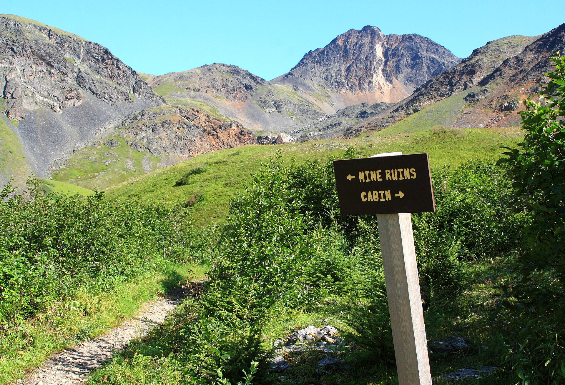 Hikers climbing an uphill trail through the mountains