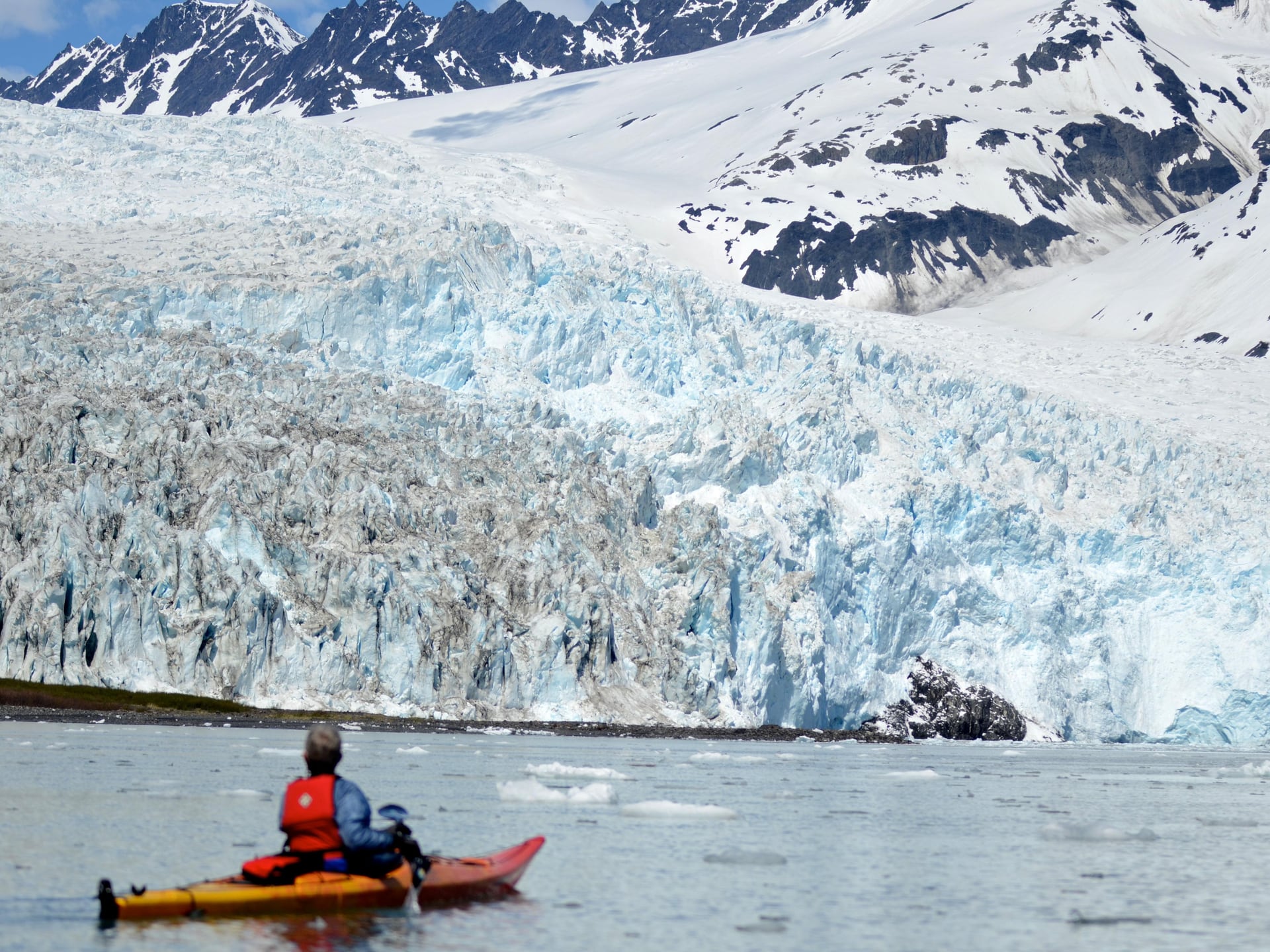 A kayaker approaching a tidewater glacier in Kenai Fjords