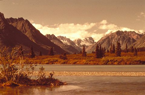 Mountains reflected in the blue water of Lake Clark National Park and Preserve