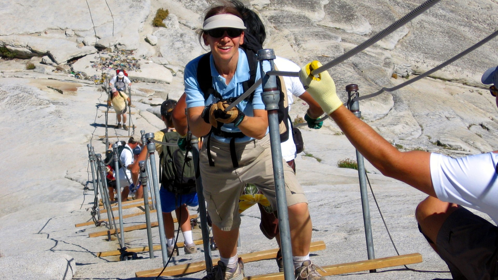 Hikers climbing the cable route on Half Dome