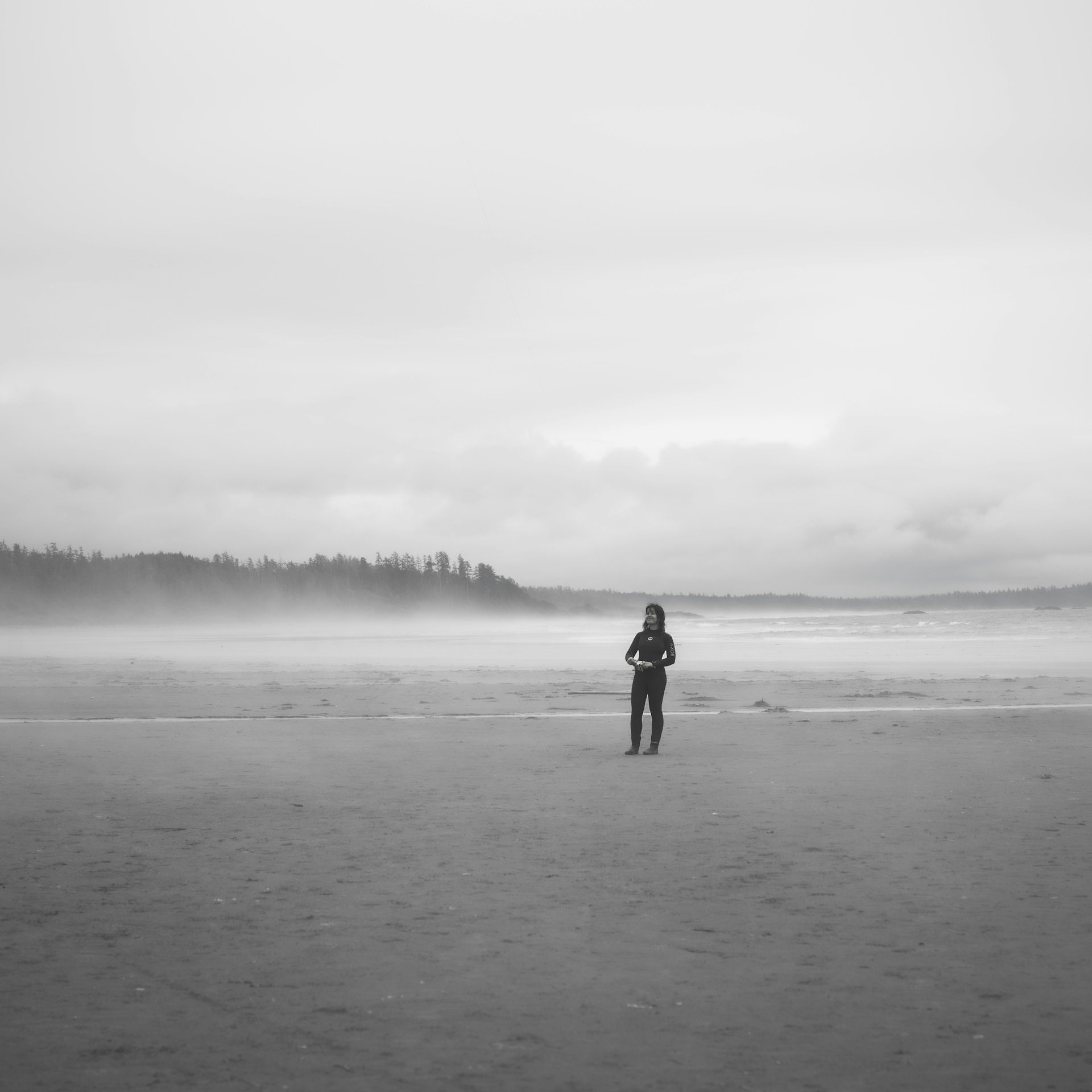 A visitor on misty Long Beach in Pacific Rim National Park Reserve