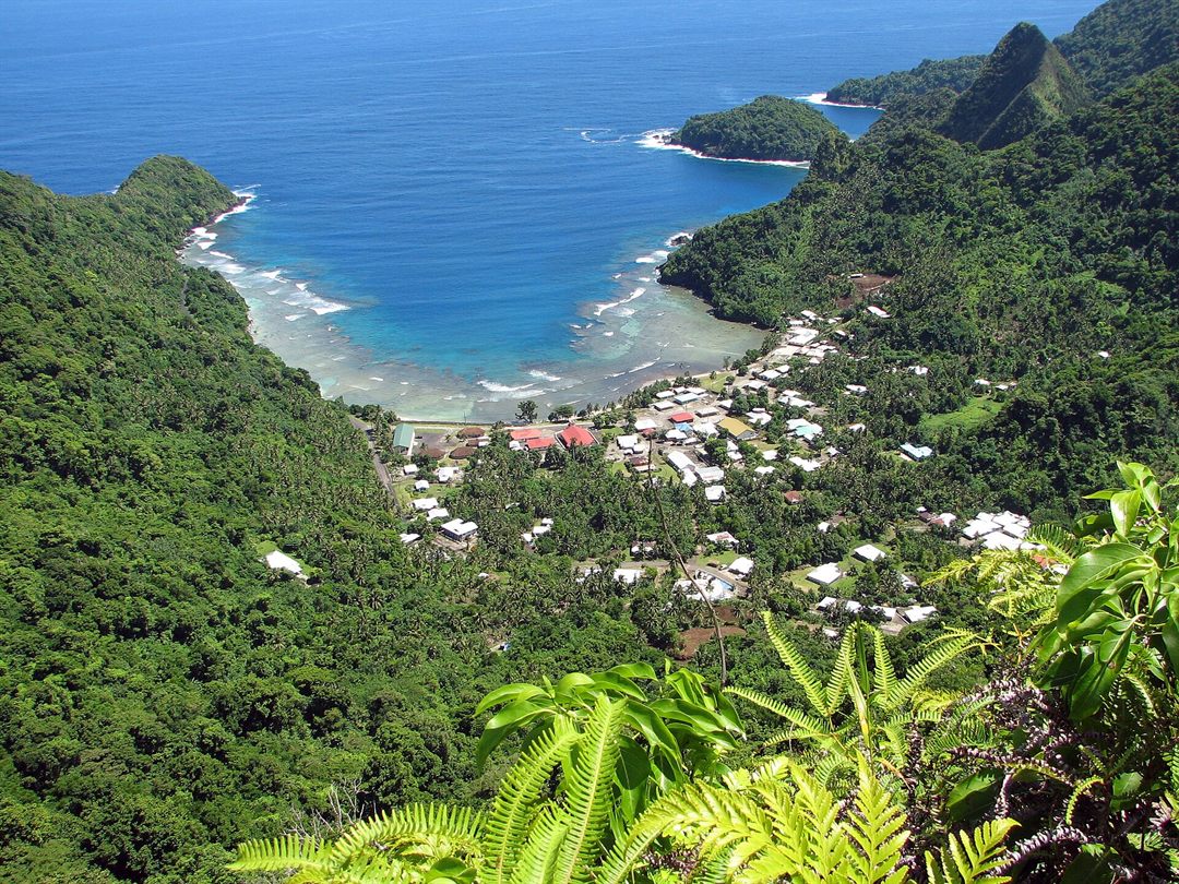 Afono village beneath steep green mountains in American Samoa
