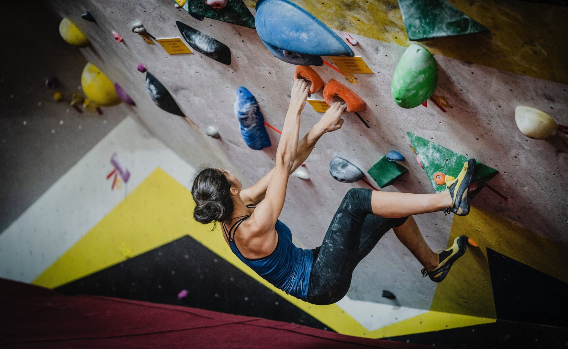 Women Rock Climbing in a Climbing Gym