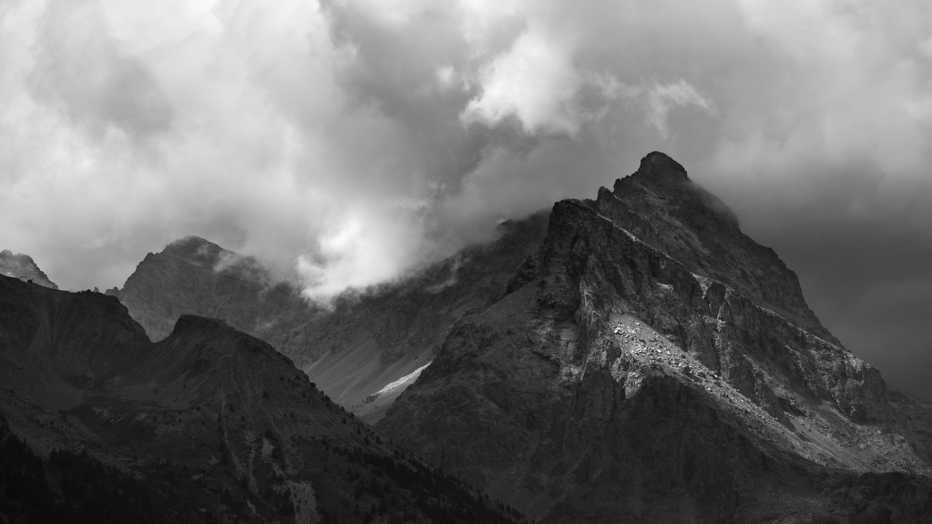 Dramatic mountain peaks beneath clouds in Écrins National Park