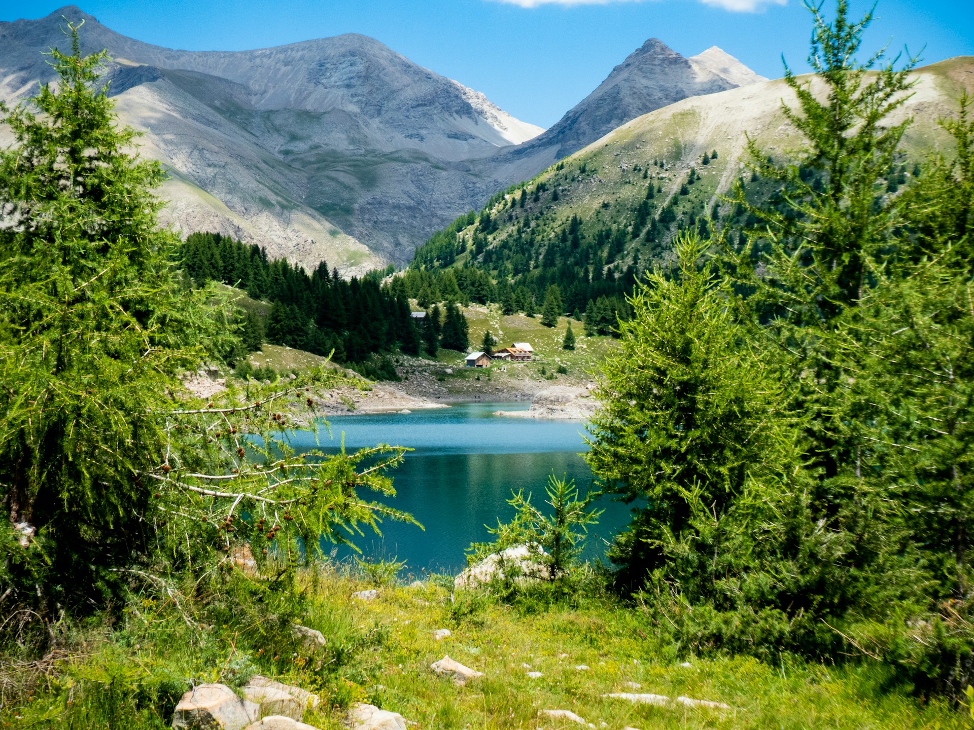 A peaceful mountain lake and chalet in Mercantour National Park