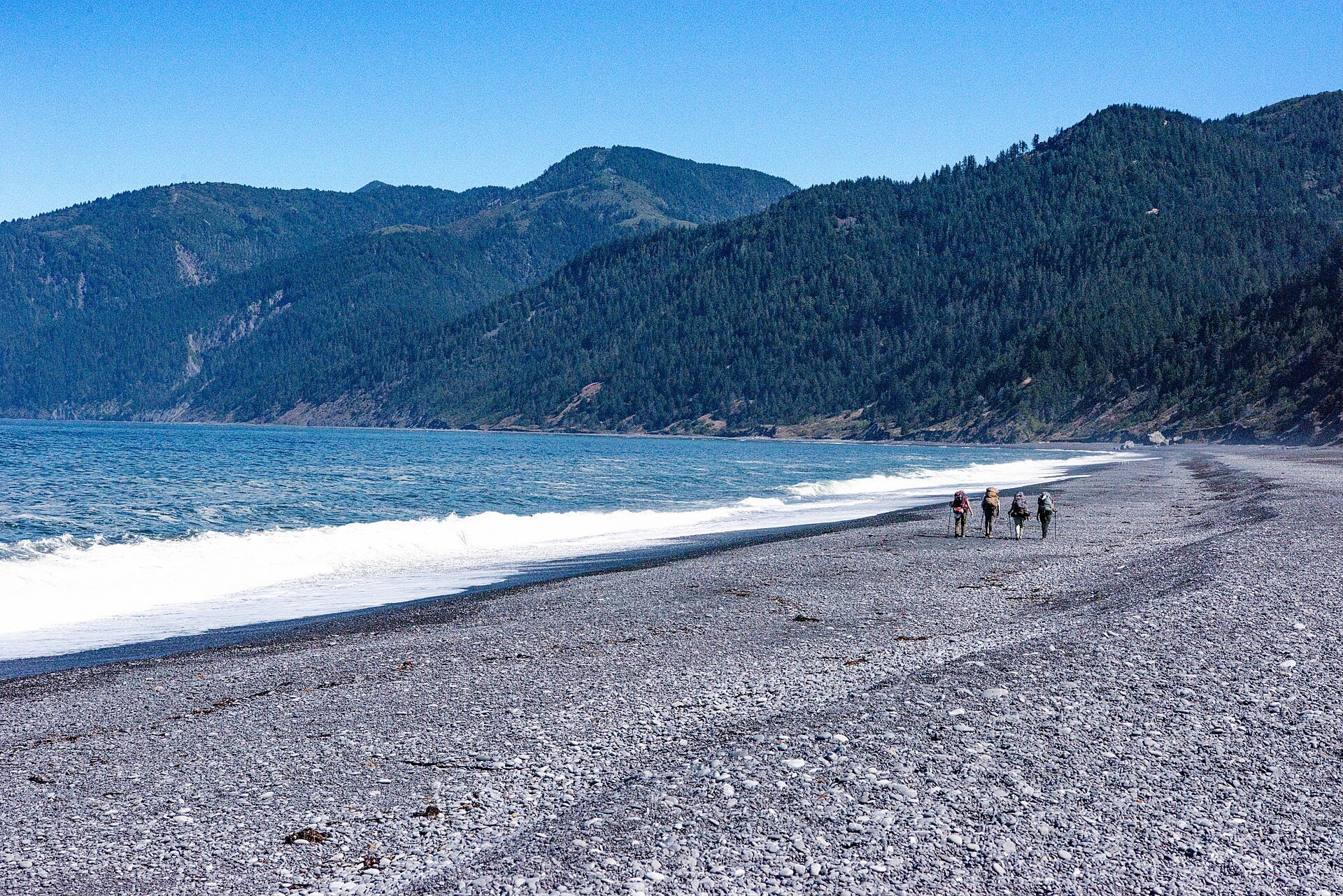 Hikers walking along the remote Lost Coast beach