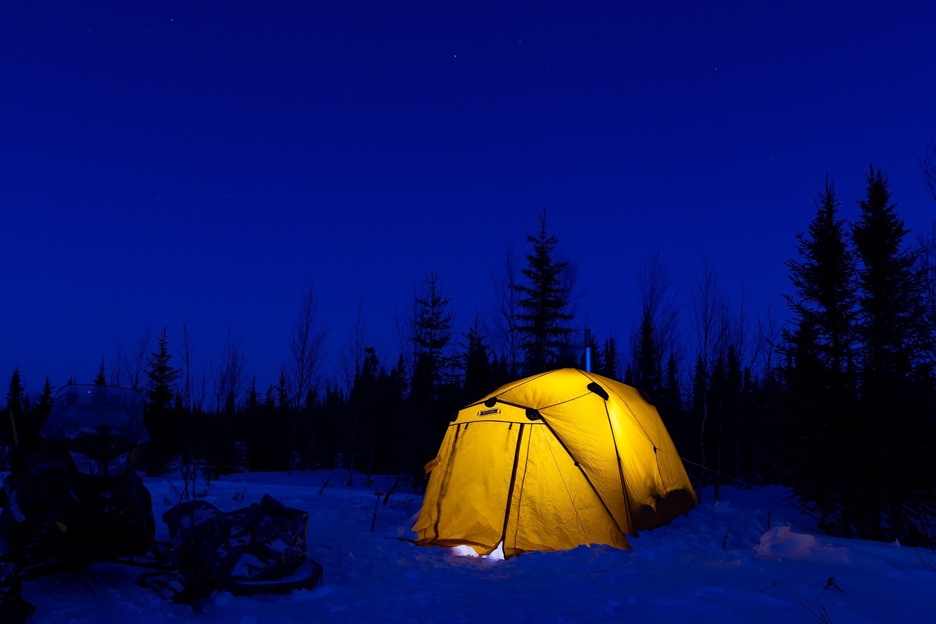 A tent at an Arctic campsite surrounded by snow