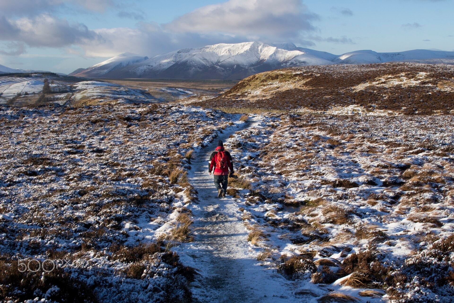 A lone hiker walking through open country