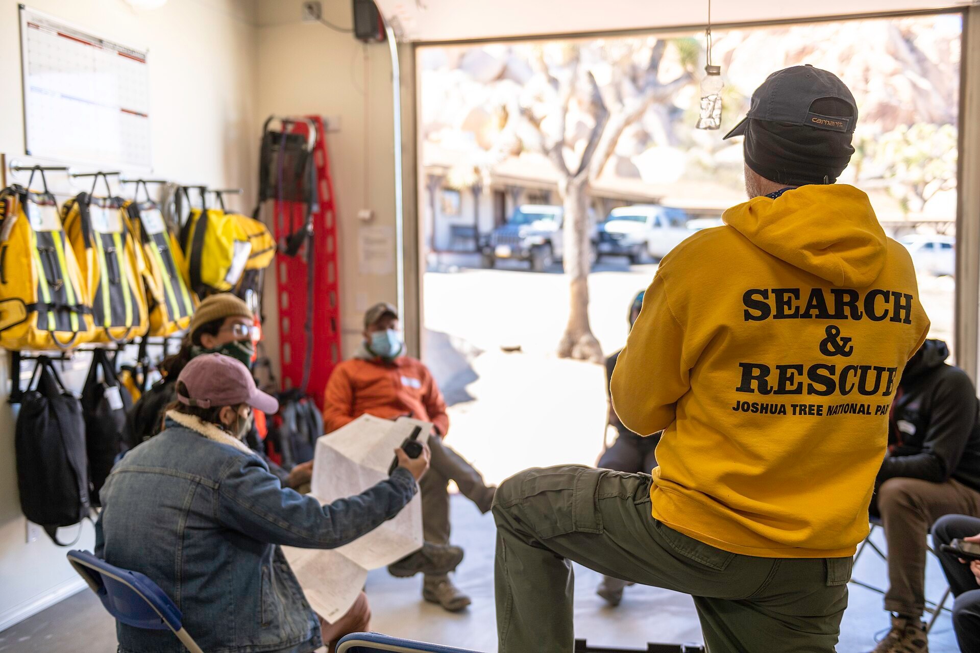 Search and rescue members training with GPS and a topographic map